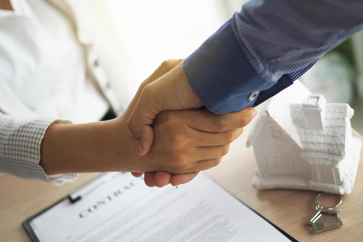 Buyers and sellers agree to enter into a house purchase agreement. Home rentals, home sales and home buying contracts. photo