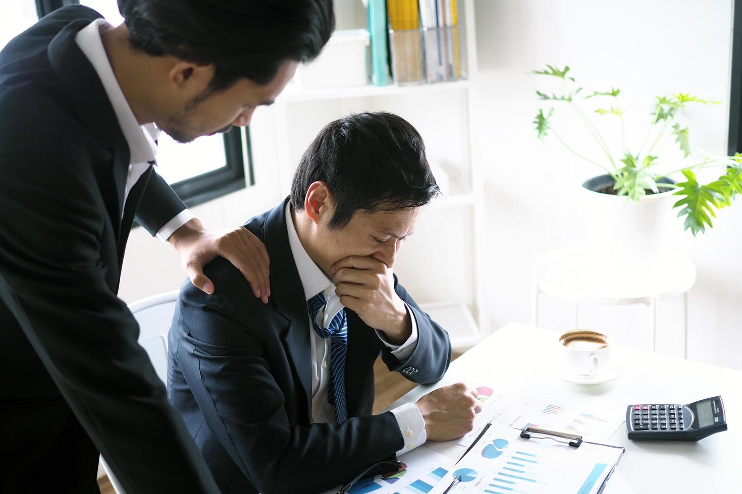 Businessmen comforted colleagues who were stressed. photo