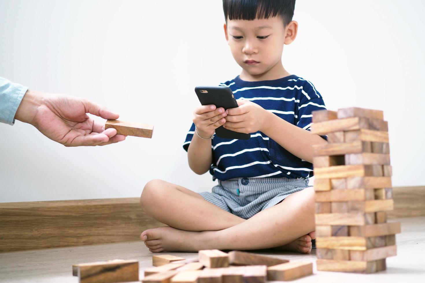 Asian children in the age of social networks that focus on phones or tablets. Do not care about the surrounding environment and have eye problems. photo