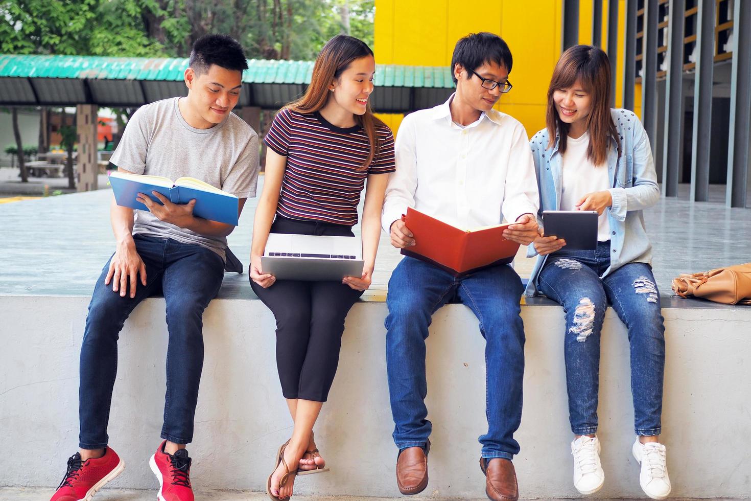 A group of high school students sit together to study in the area of the university. photo