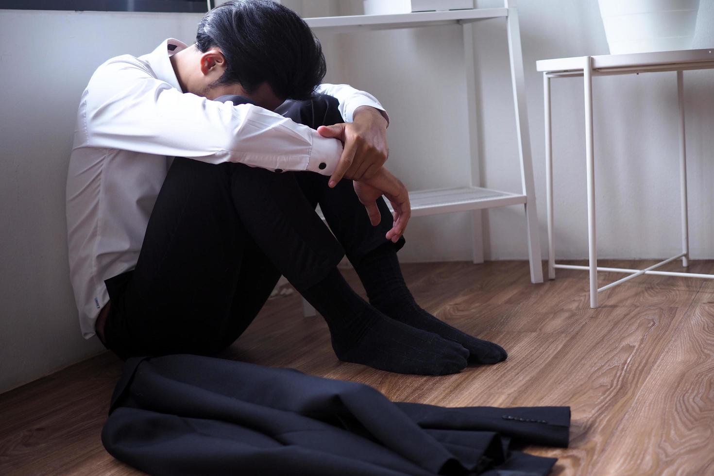 Businessmen sitting inside the office alone are stressed. photo