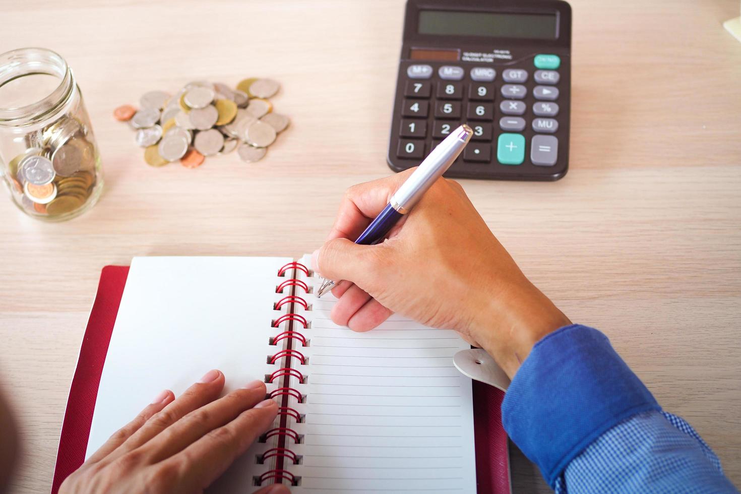 The young butler is recording the expenses in the house. Financial reports and calculations about investment costs and financial data analysis. photo