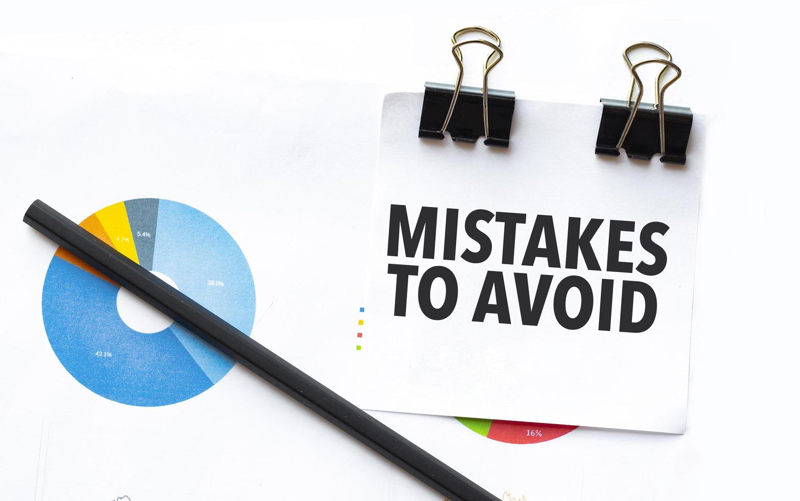 Mistakes To Avoid on notebook with charts and pencil 19051101 Stock ...