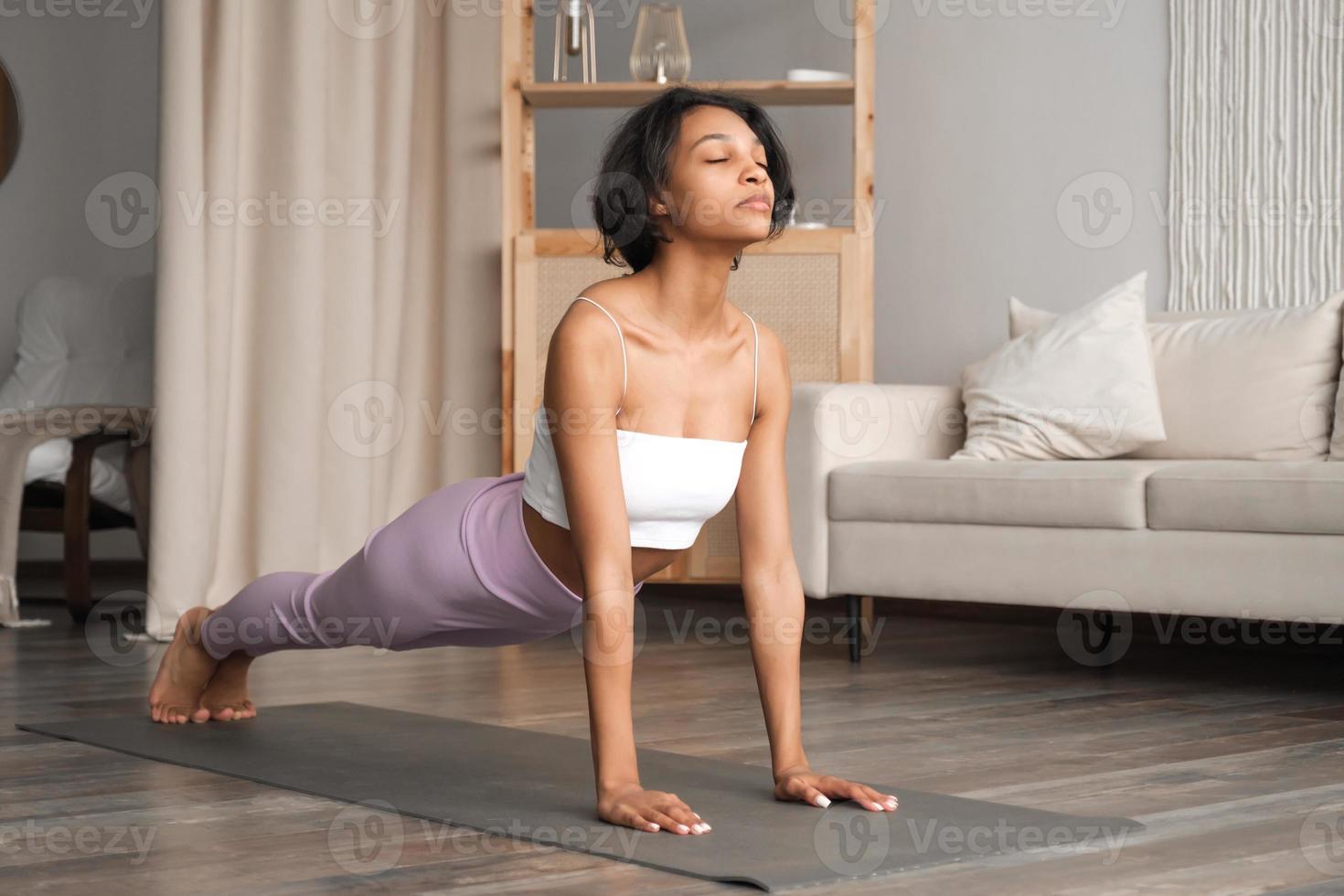 Yoga concept with happy woman in asana at home. Zen and wellness concept with place for text photo