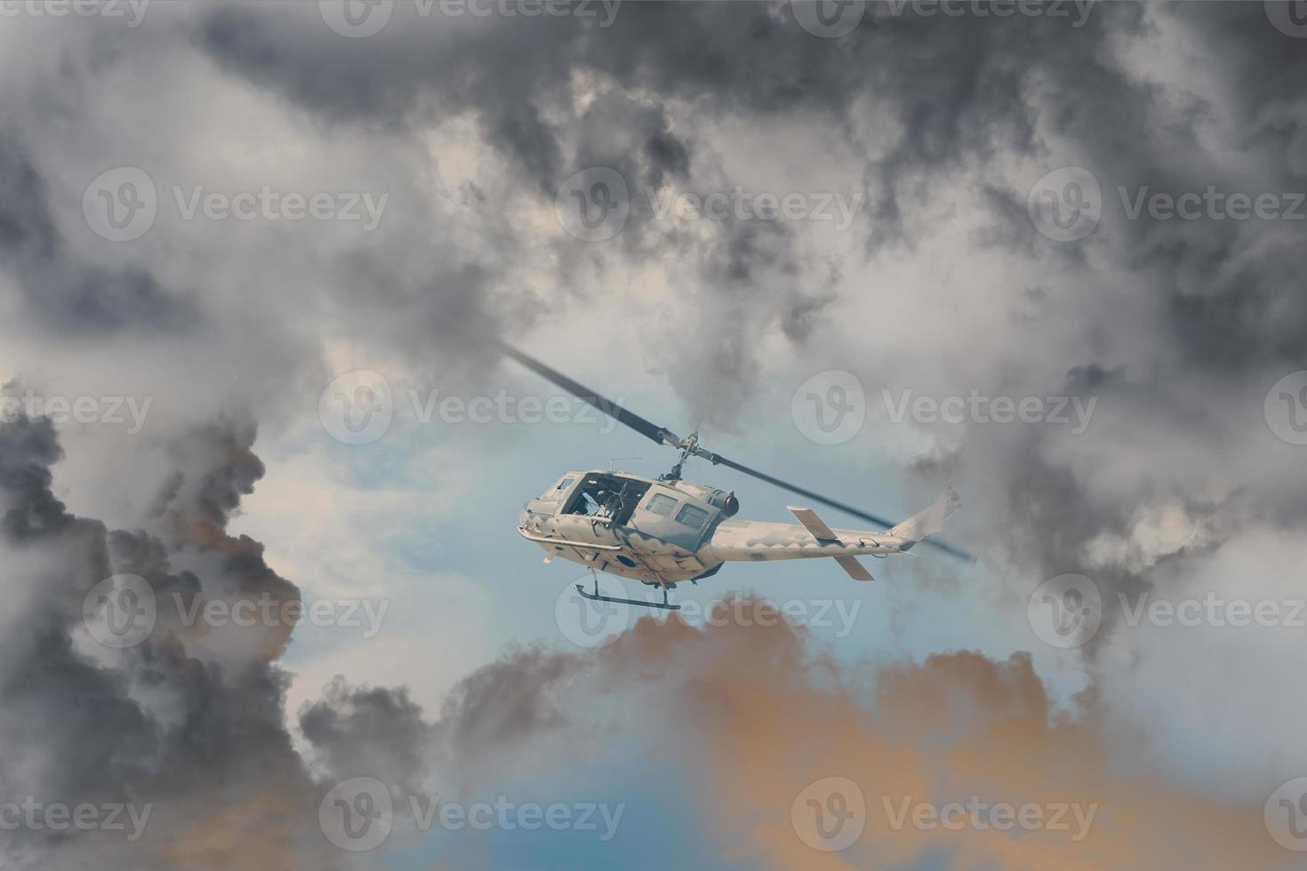 A Rescue Helicopter races against an oncoming Storm severe weather,Modern attack helicopter with with weapons photo