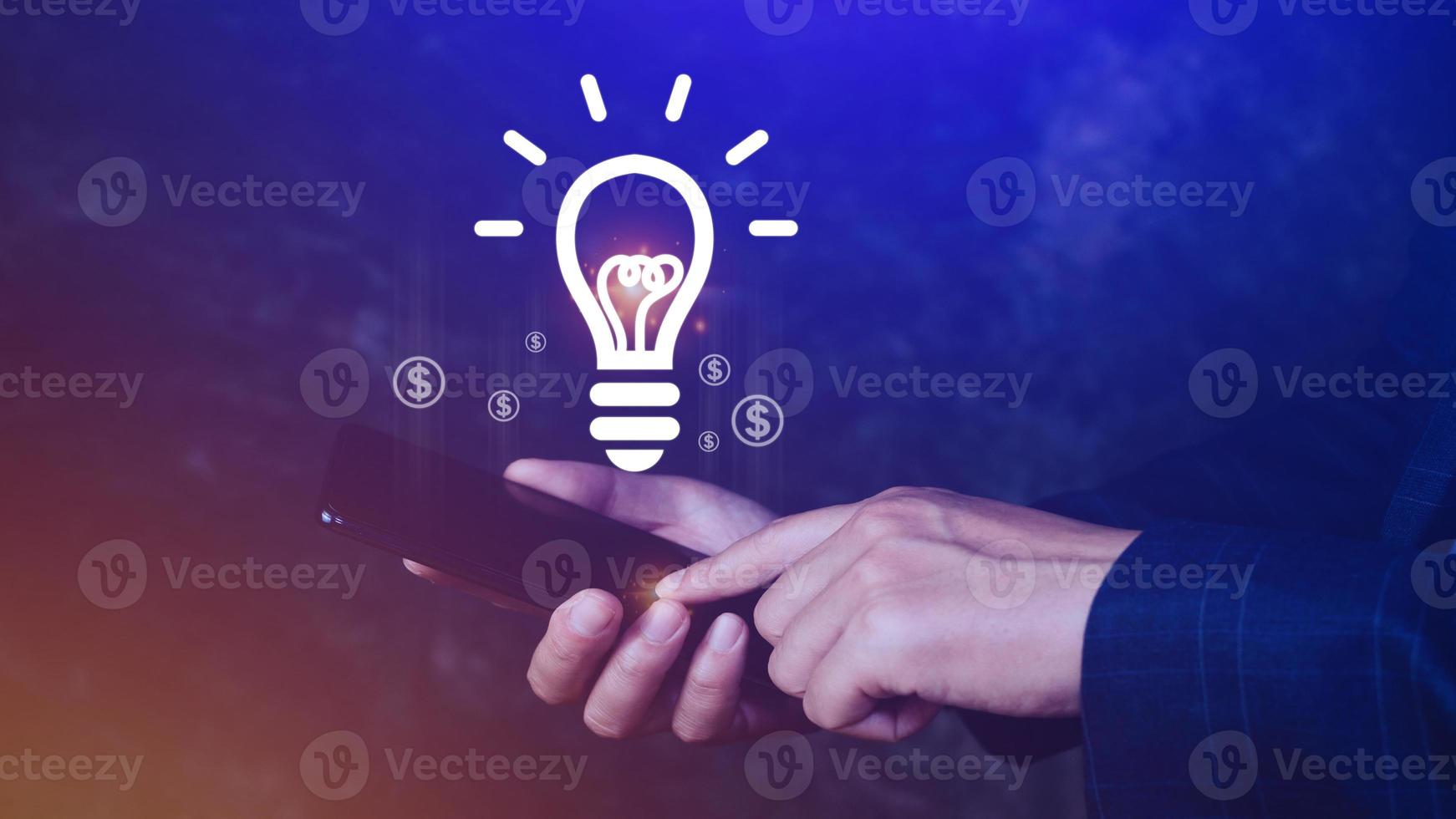 Hands holding smartphone with light bulb Bright idea, light bulb for concept new idea concept with innovation and inspiration, technology in science and communication concept photo