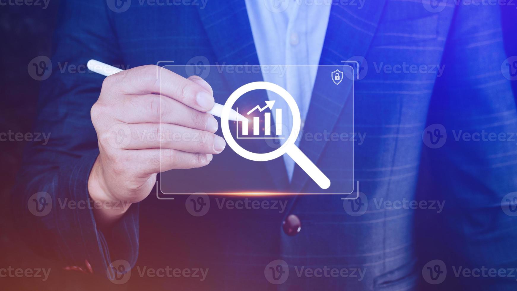 Businessman showing business growth on graph Hands touching graphs representing increasing profits with virtual interface technology, financial symbols coming photo