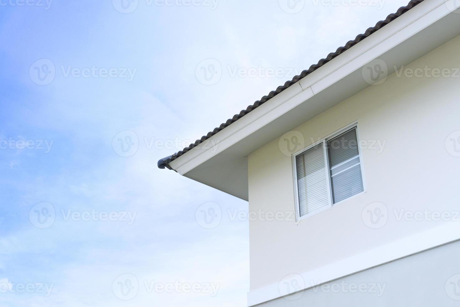 House roof with large windows on blue sky background,generic view to facade of a new modern building with blue sky photo