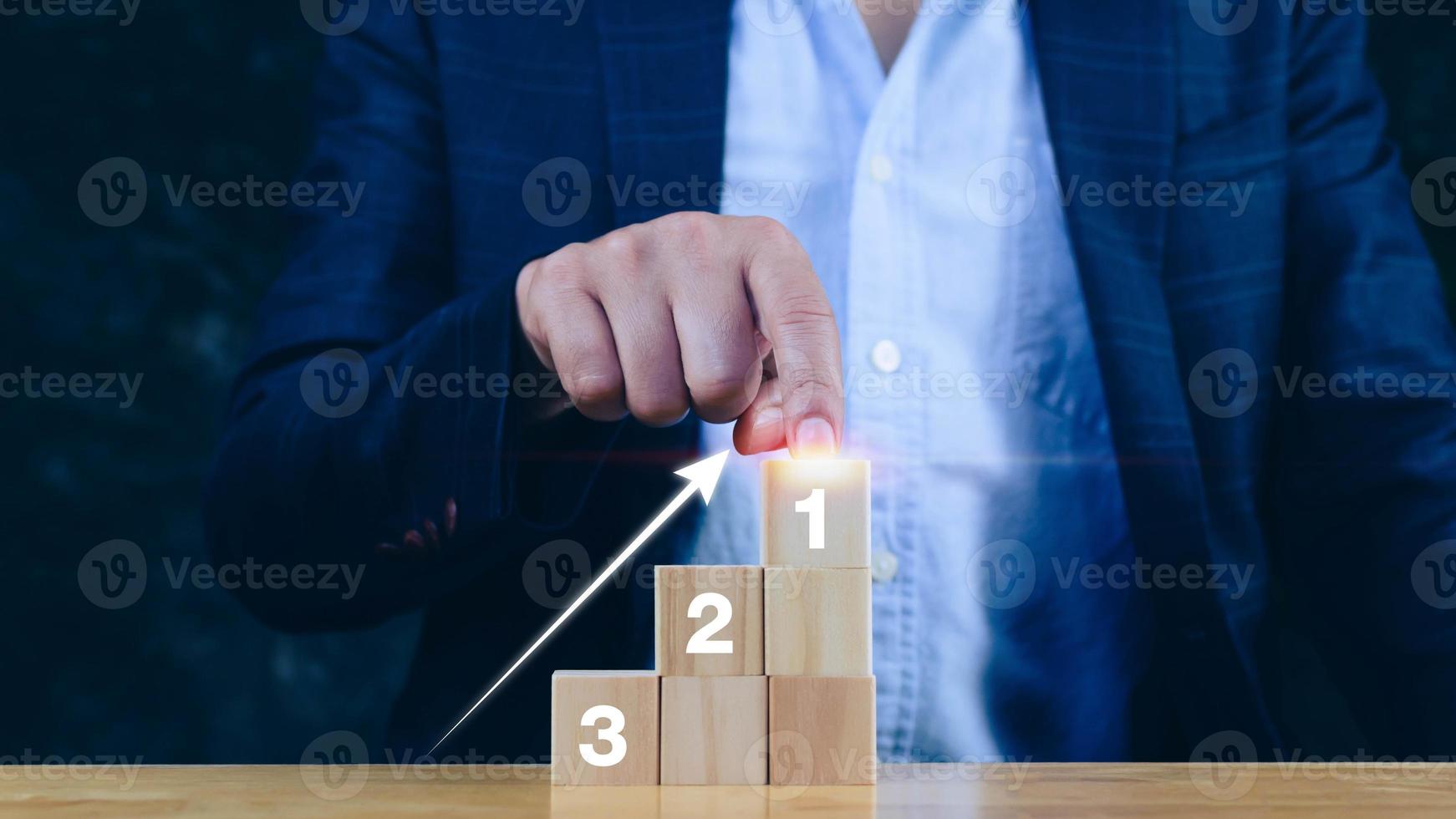 Businessman  hand choose the wooden block with number 1 sign and up arrow, Concept of success ,winner, victory or top ranking. step by step photo