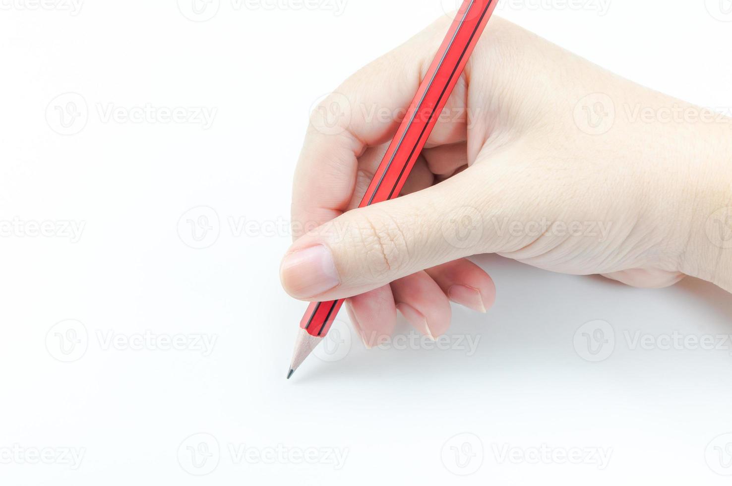 Woman s hand holding a red pencil On white background photo