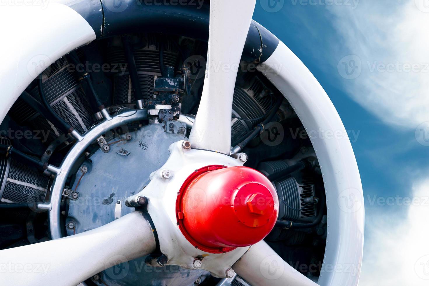 Vintage airplane propeller with radial engine on a beautiful blue sky photo