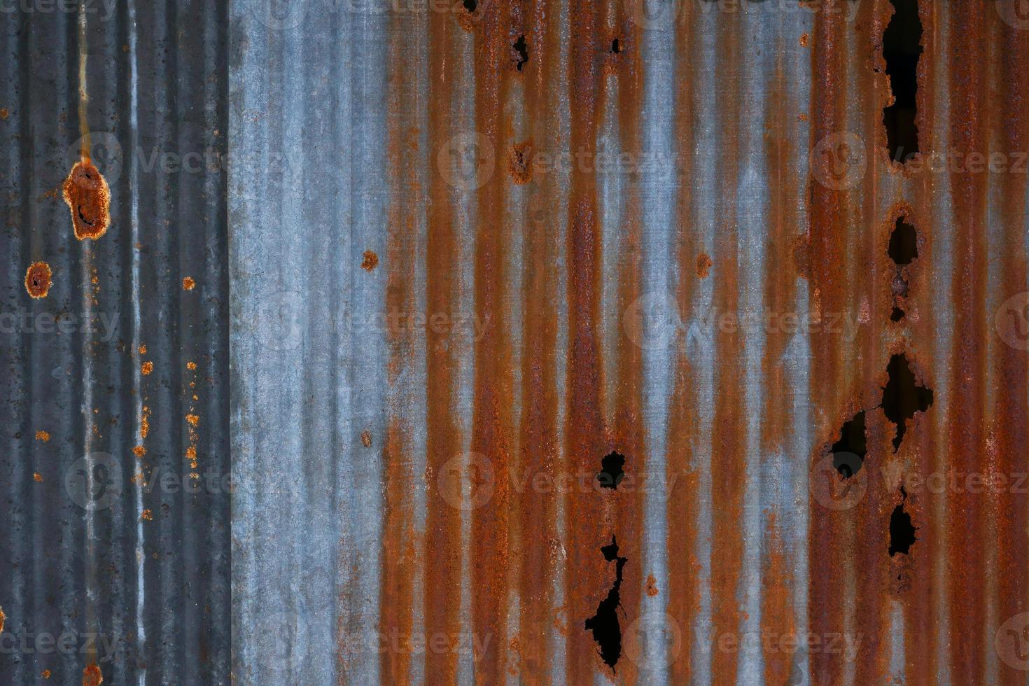 The tin roof background with the old rust and nails hole by vintage style.Galvanized iron steel plates with rust for background photo