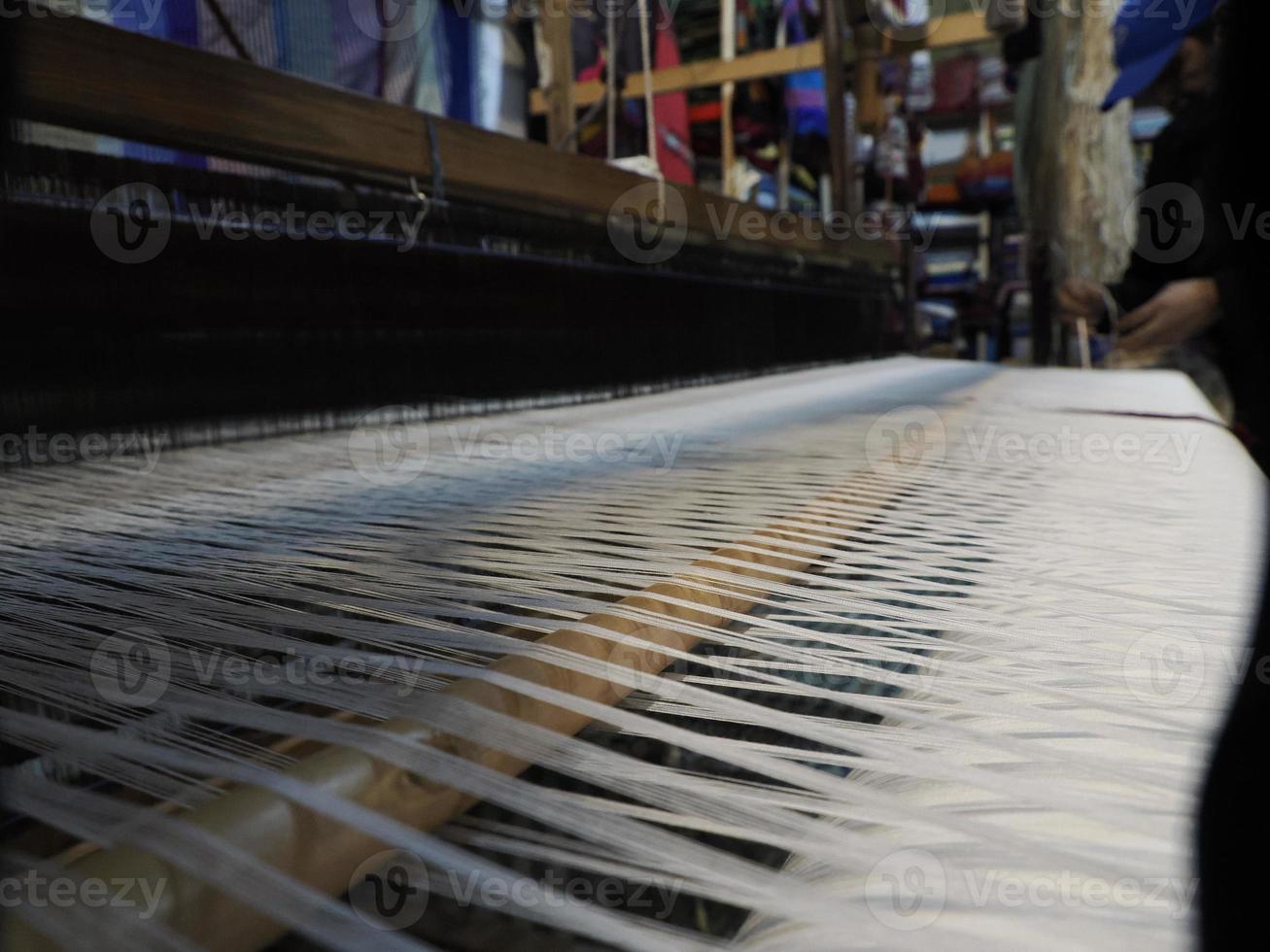 Close up of the threads in a wooden loom in a textile store in Fes, Morocco photo