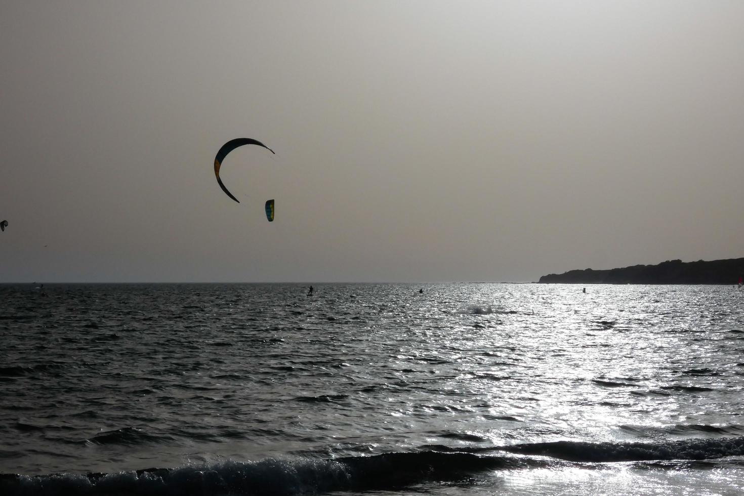 windsurfing, kitesurfing, water and wind sports powered by sails or kites photo