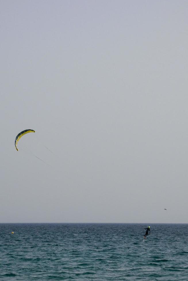 windsurfing, kitesurfing, water and wind sports powered by sails or kites photo