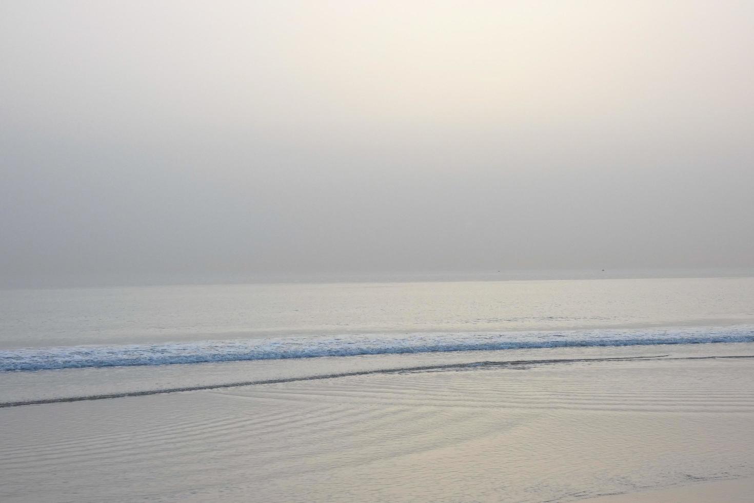 lonely, uncrowded beach with calm sea and small waves photo