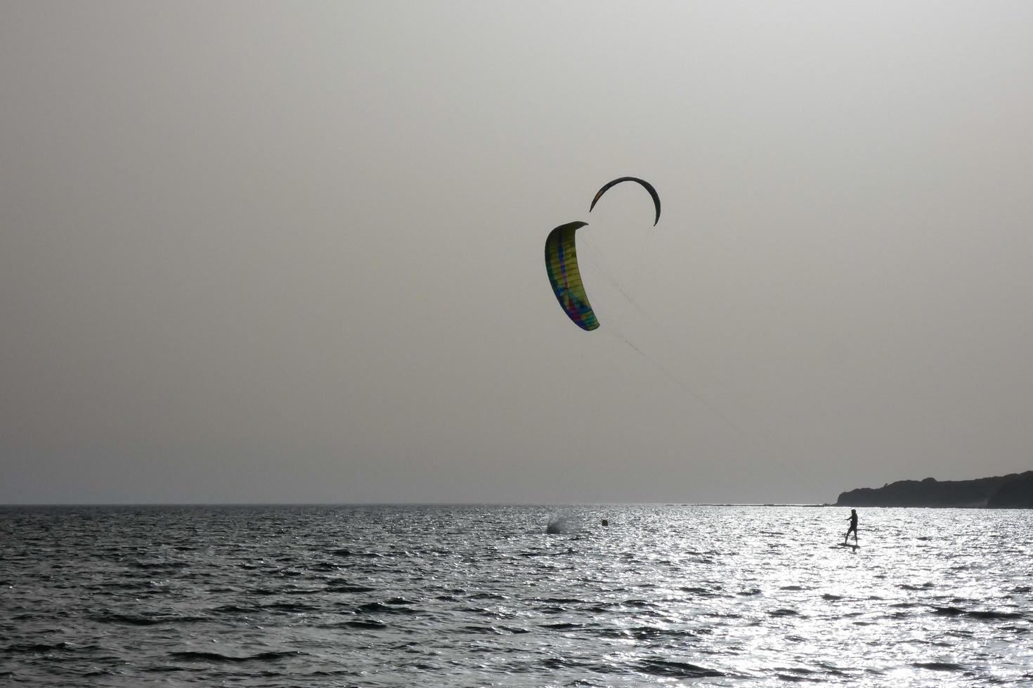 windsurfing, kitesurfing, water and wind sports powered by sails or kites photo