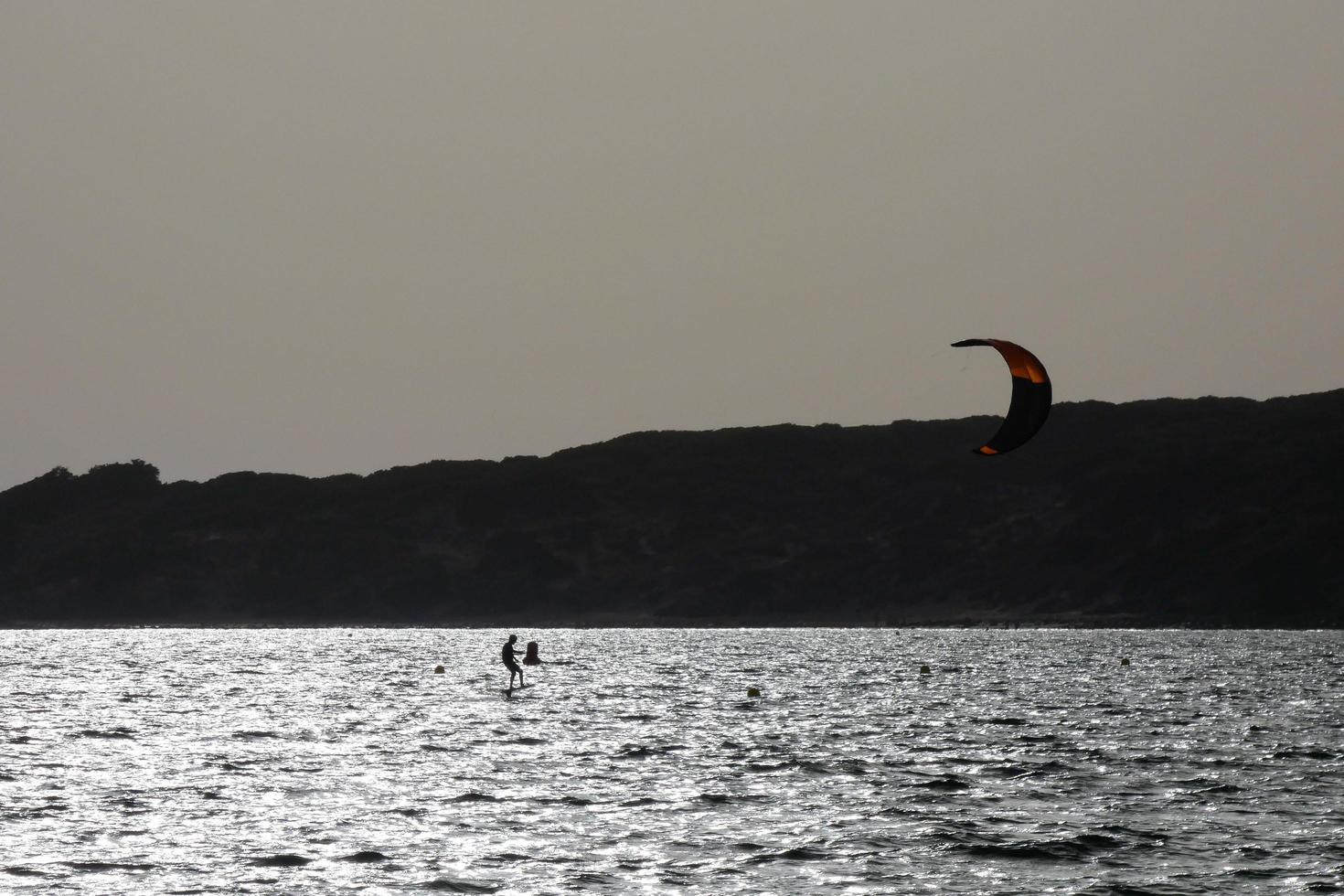 windsurfing, kitesurfing, water and wind sports powered by sails or kites photo