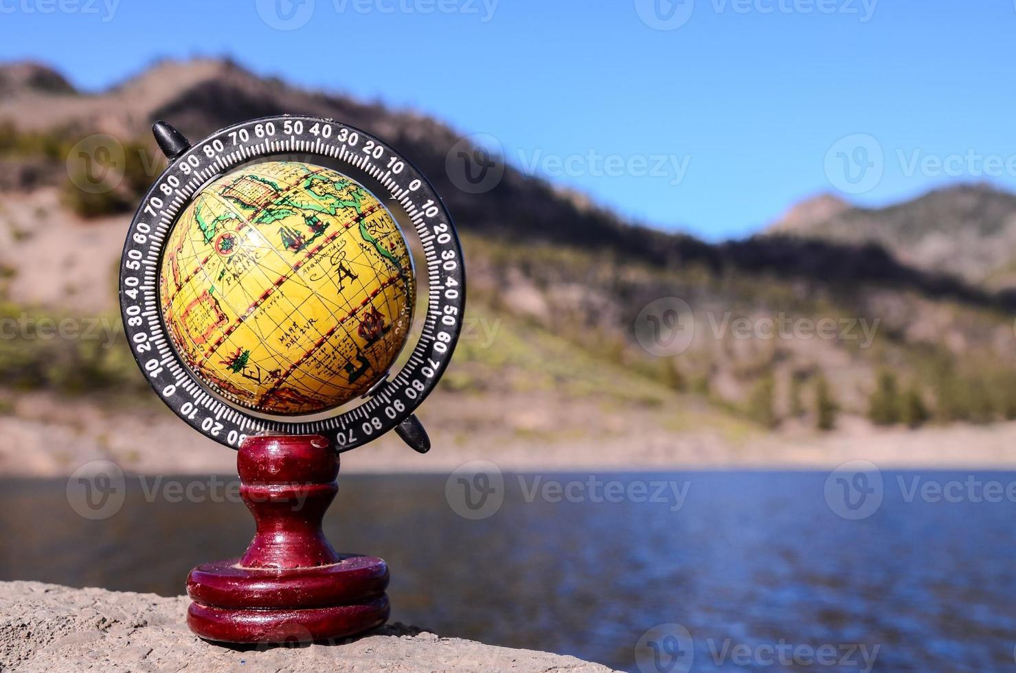 Globe by the ocean photo