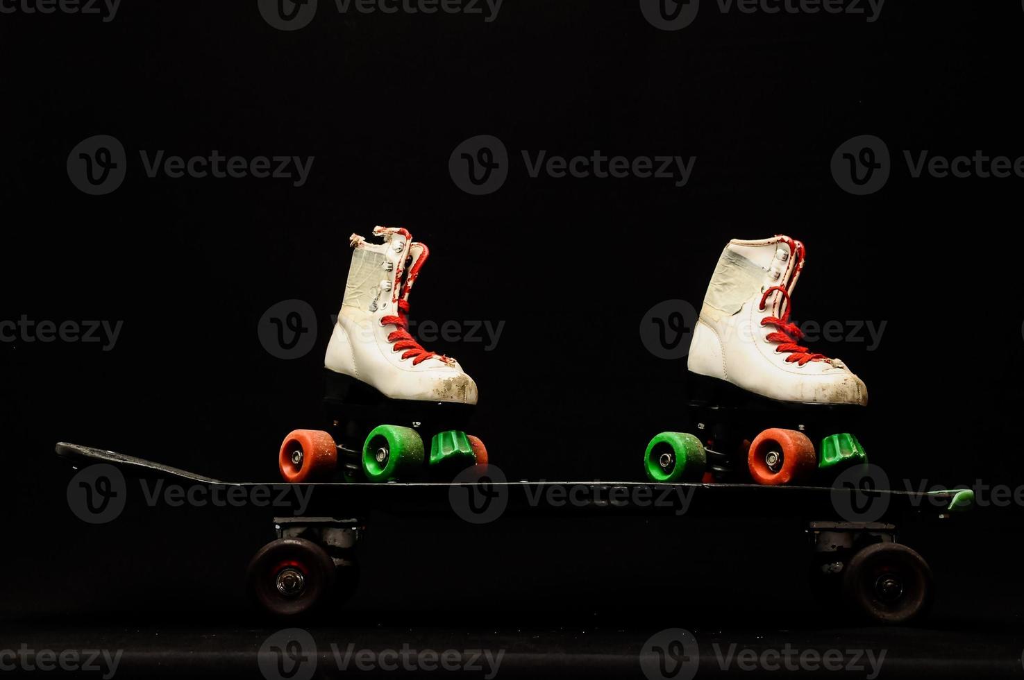 Skateboard and roller skates photo