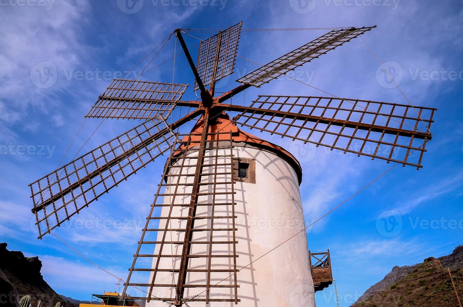 Traditional windmill under blue sky photo