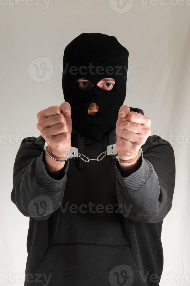 Handcuffed man in black photo