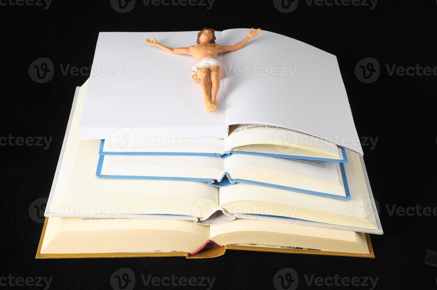 Small Jesus Christ figure on open books photo