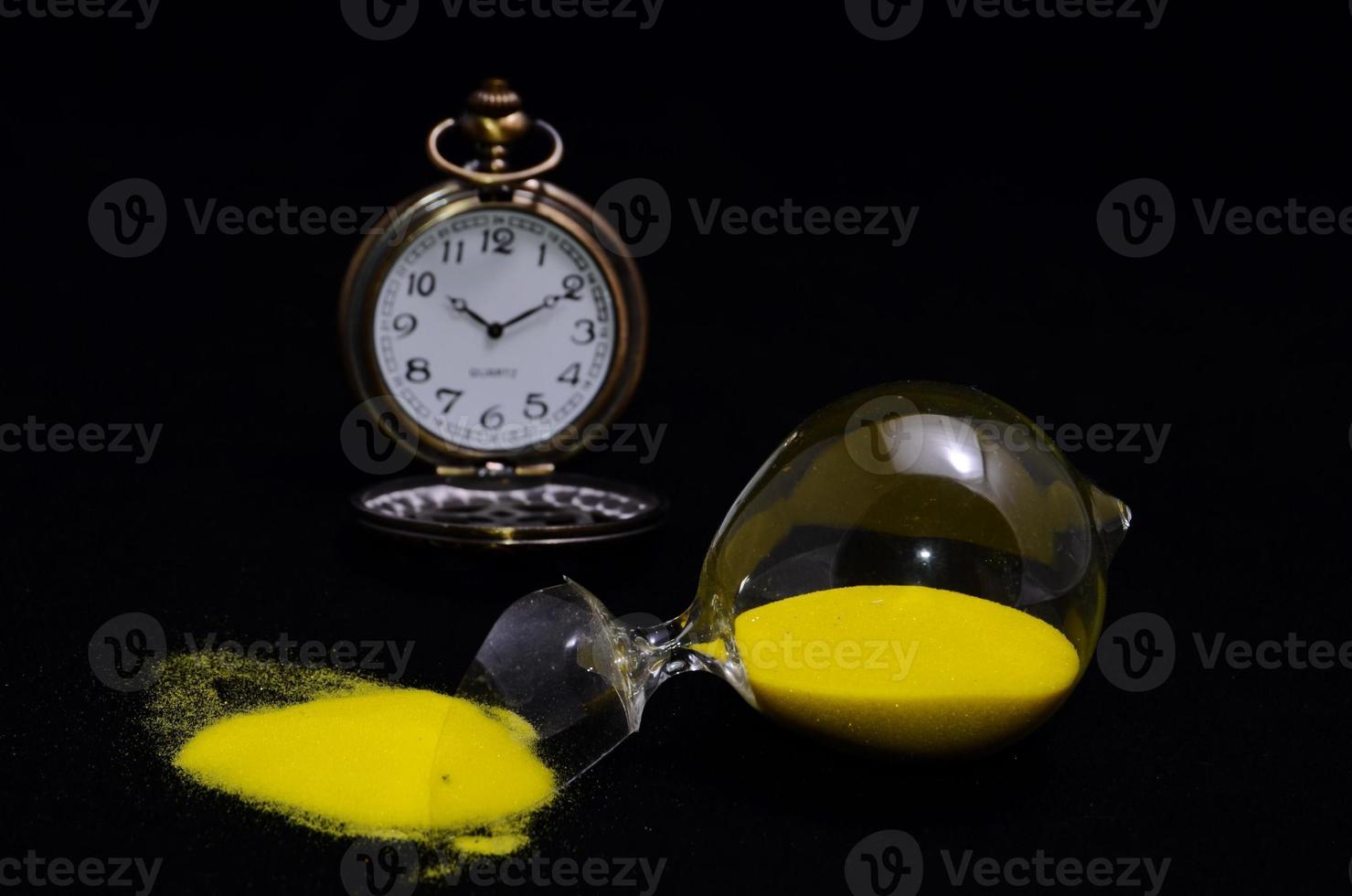 Pocket watch and a broken hourglass photo