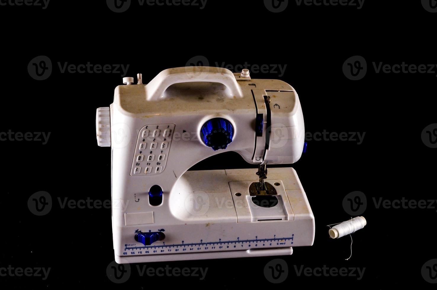 Sewing machine on black background photo