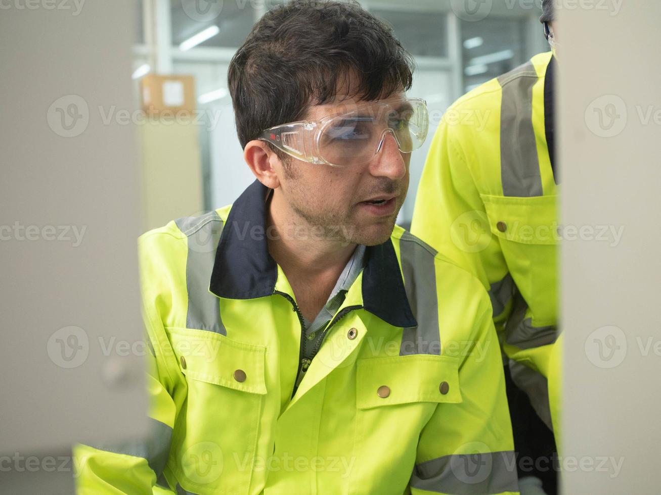 Foreman staff uniform engineer maintenance supervisor operation wear glasses look work monitor report candid work job conversation technology industry repair metal steel part architecture work job photo