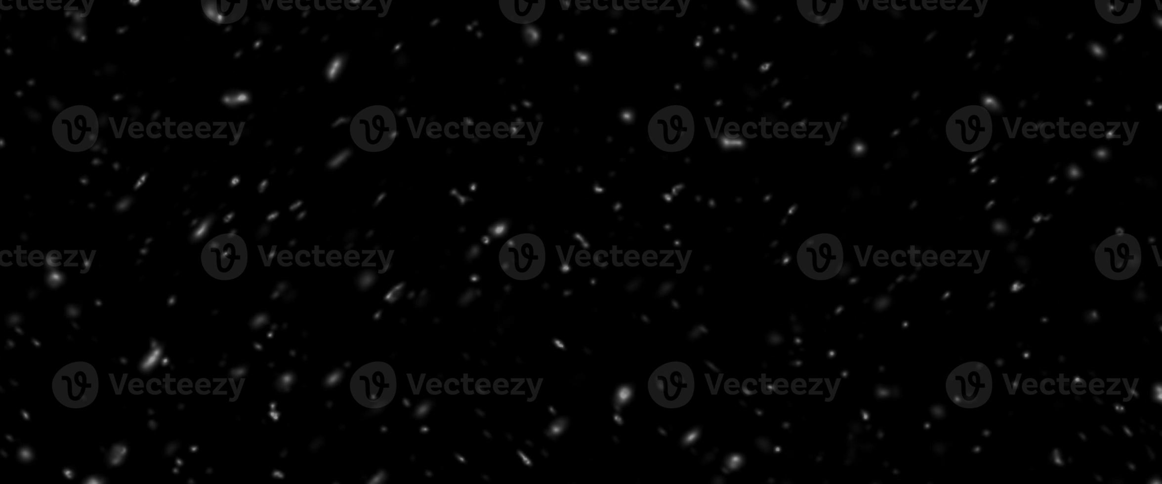 Falling snow isolated on black background. Falling snow at night. Bokeh lights on black background, flying snowflakes in the air. Winter weather photo