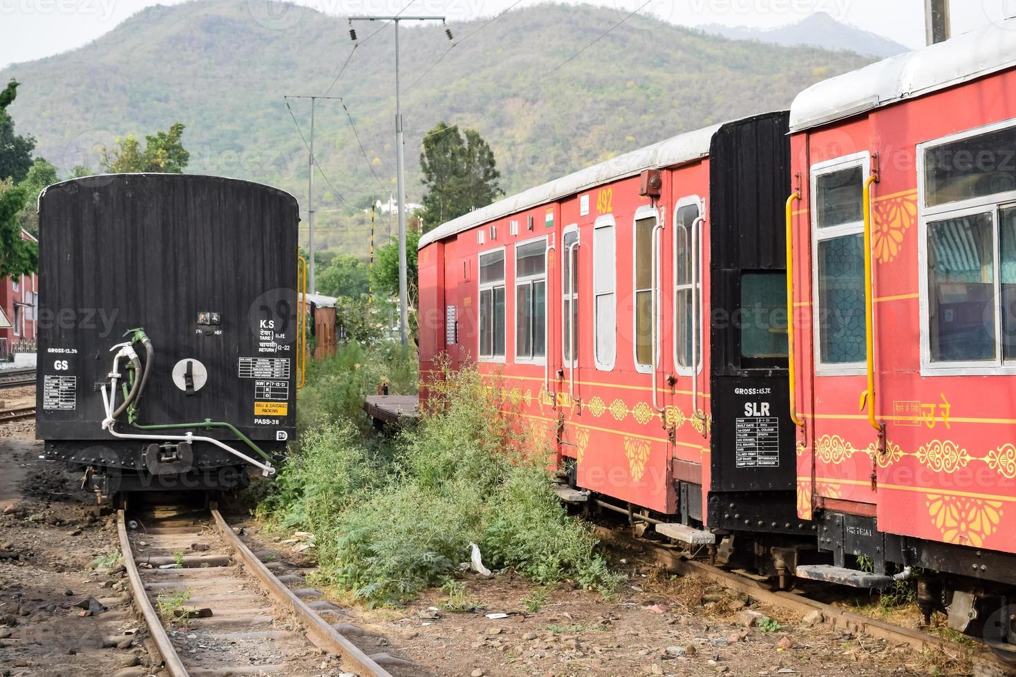 View of Toy train coach from the middle of railway track during daytime near Kalka railway station in India, Toy train coach view, Indian Railway junction, Heavy industry photo