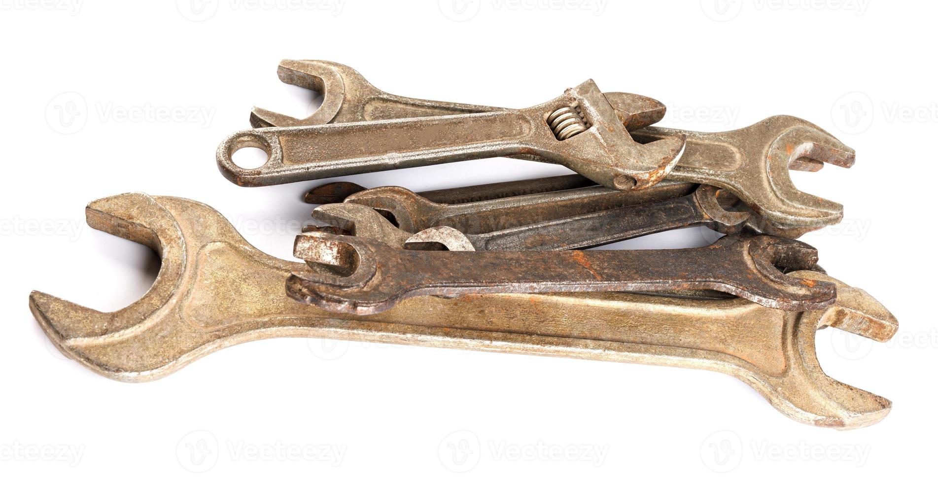 A lot of wrenches of different sizes lie in a pile on a white background. Wrenches isolated on white background. photo