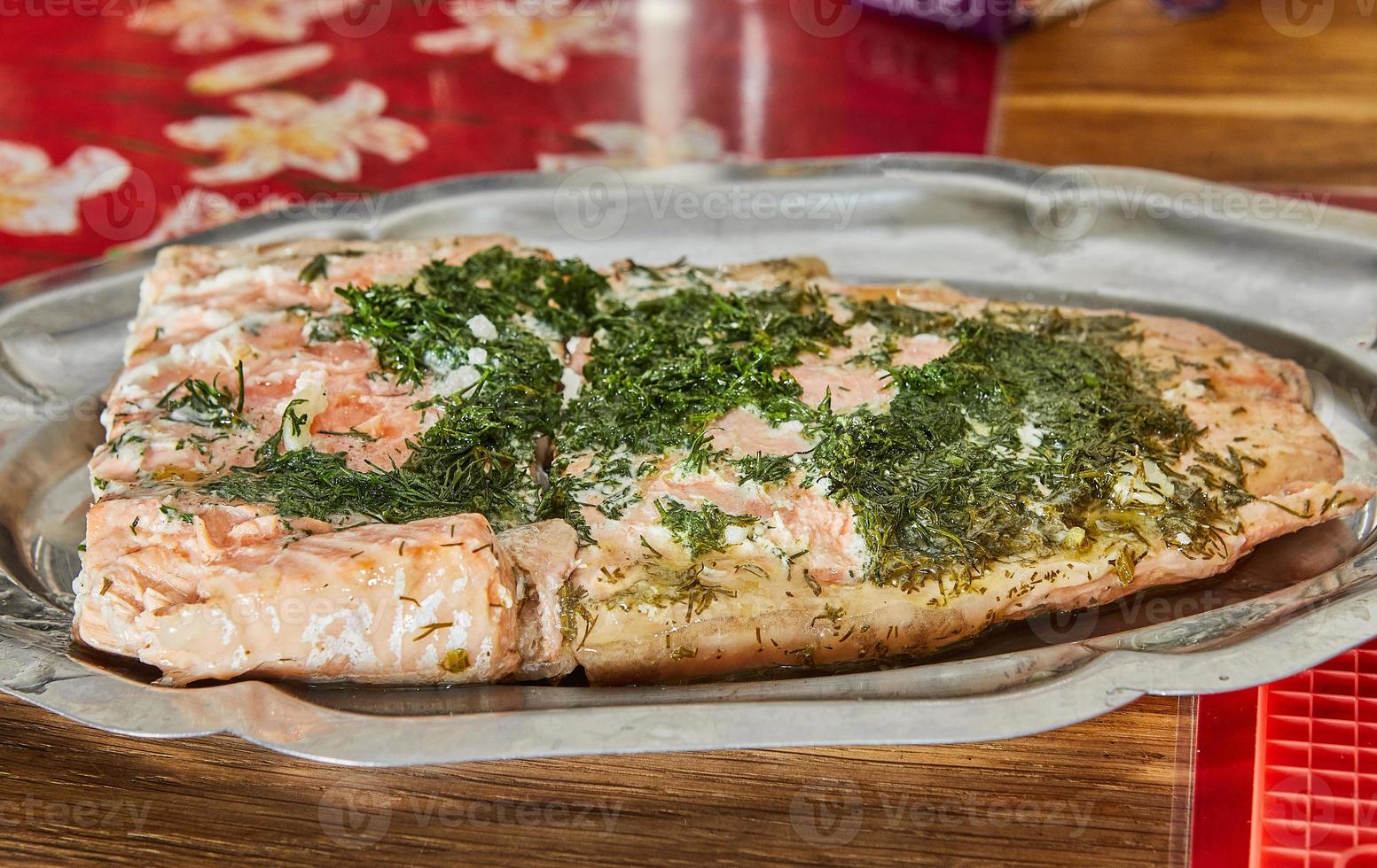 Salmon with garlic and herbs after baking in the oven on tray photo