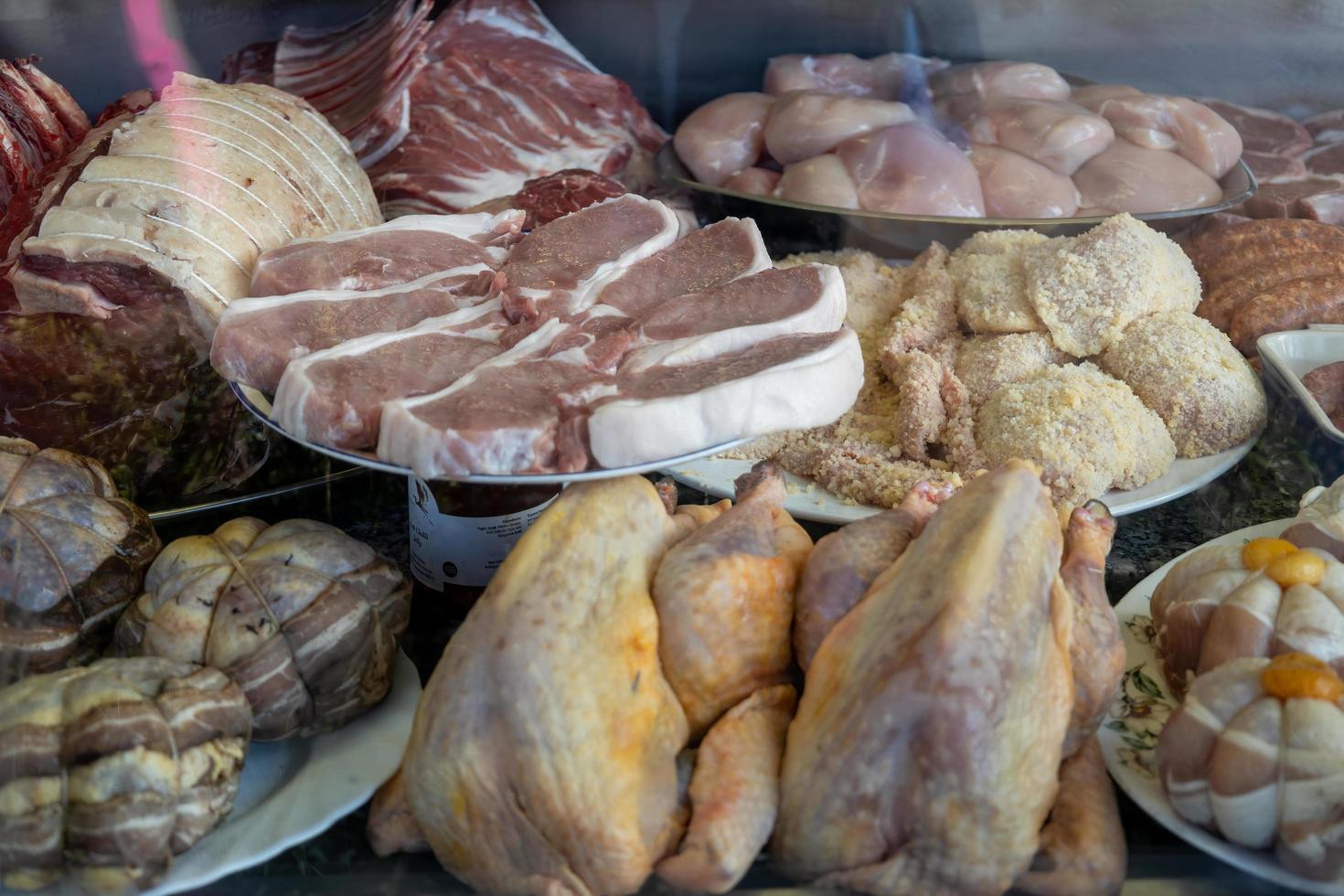 LINDFIELD, WEST SUSSEX, UK - FEBRUARY 01. Window display of various cuts of meat in a butchers shop in the village of Lindfield West Sussex on February 01, 2023 photo