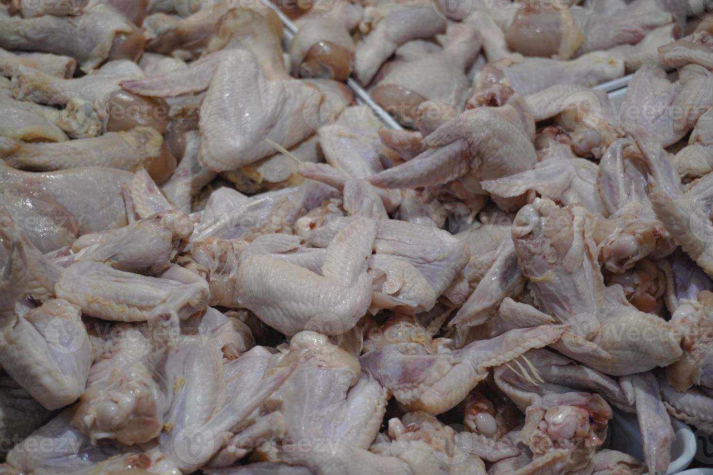 Photo of raw chicken portions for cooking and barbecuing with skinless breasts and diced strips for goulash or stir fry with legs and wings with skin viewed from above
