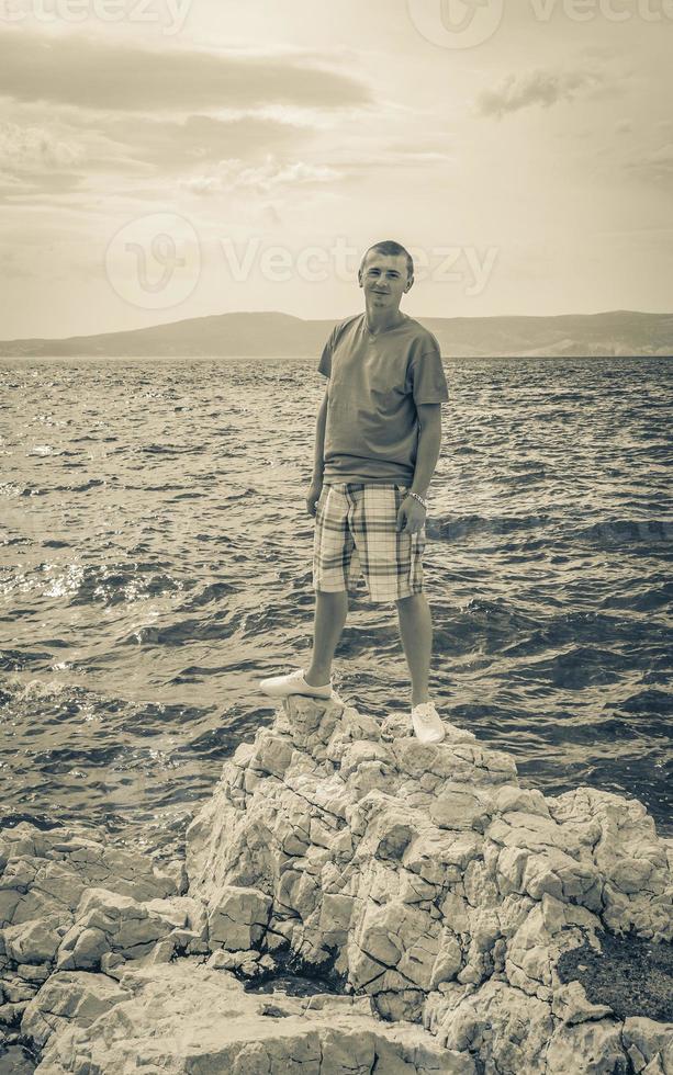 Young male model at Mediterranean landscape in Novi Vinodolski Croatia. photo