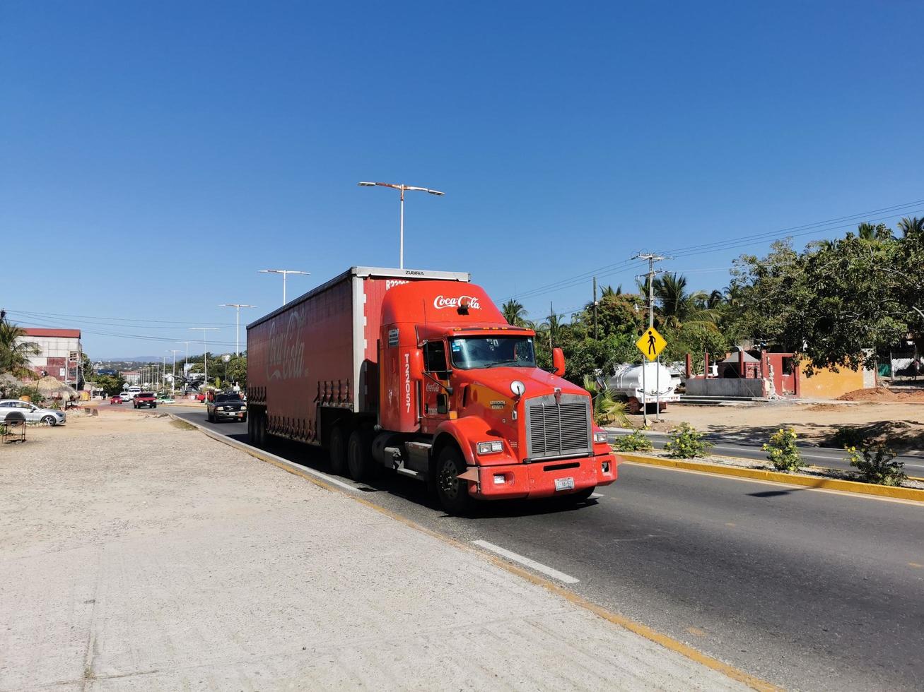 Puerto Escondido Oaxaca Mexico 2023 Red Coca Cola trucks cargo transporter delivery cars in Mexico. photo