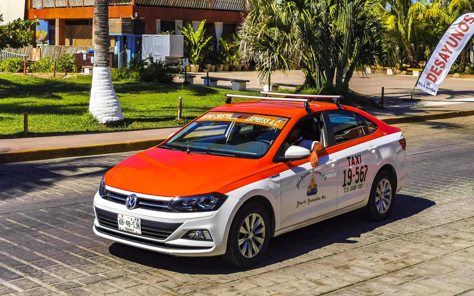 Puerto Escondido Oaxaca Mexico 2023 Red orange colorful taxi cab car in Puerto Escondido Mexico. photo