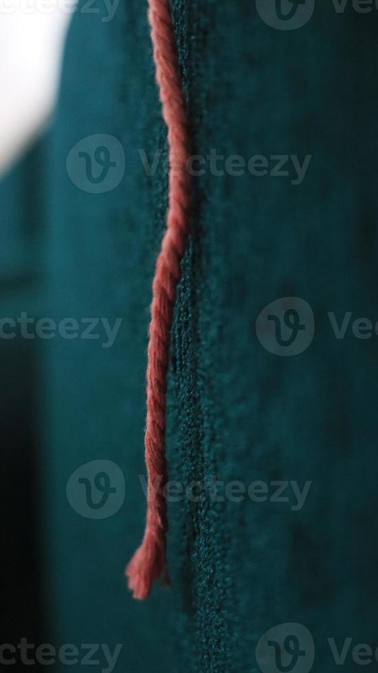 Close up of red and white rope on blue background. Selective focus. photo