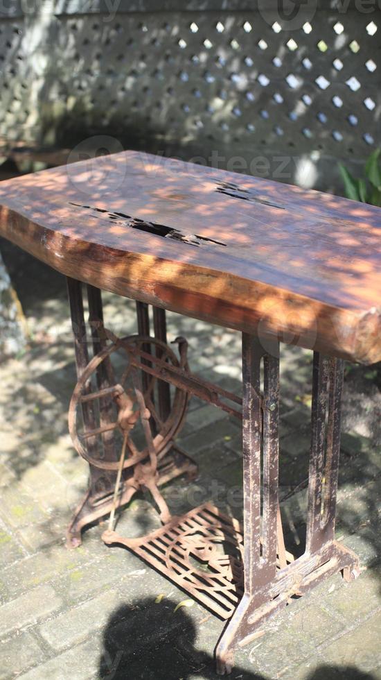 Old rusty wooden table in the garden, selective focus. photo