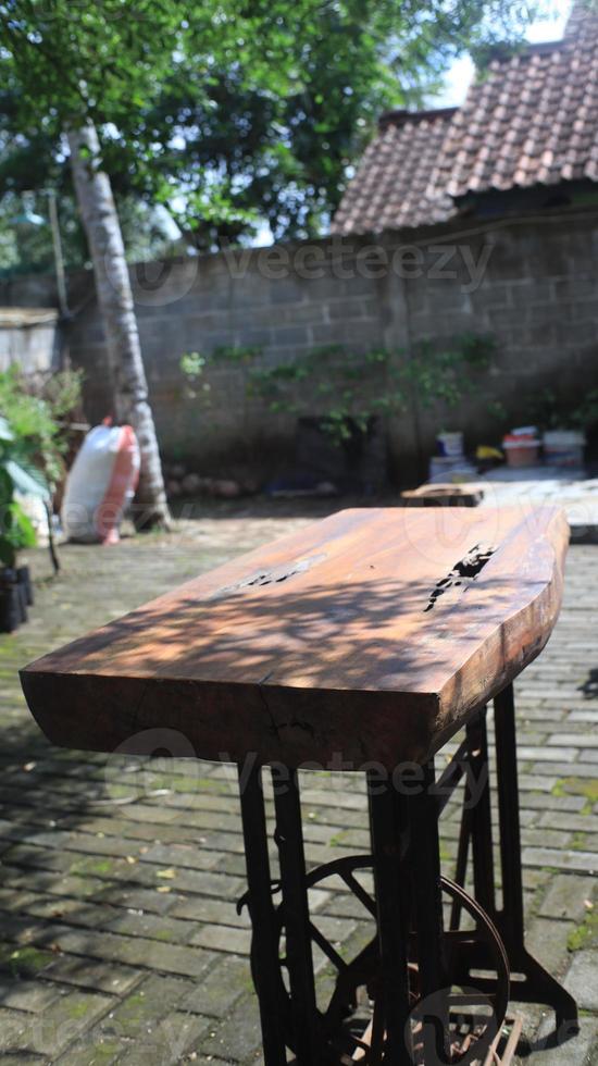 Old rusty wooden table in the garden, selective focus. photo