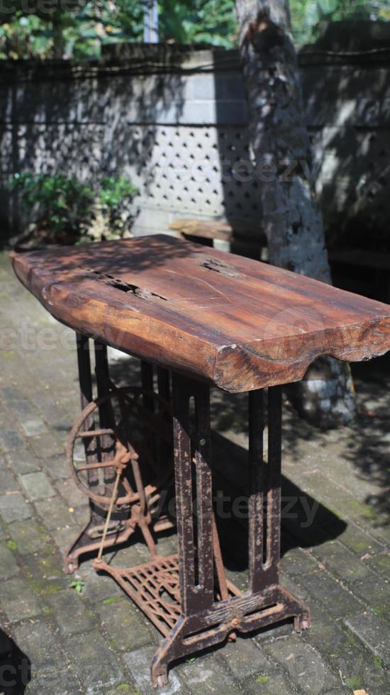 Old rusty wooden table in the garden, selective focus. photo