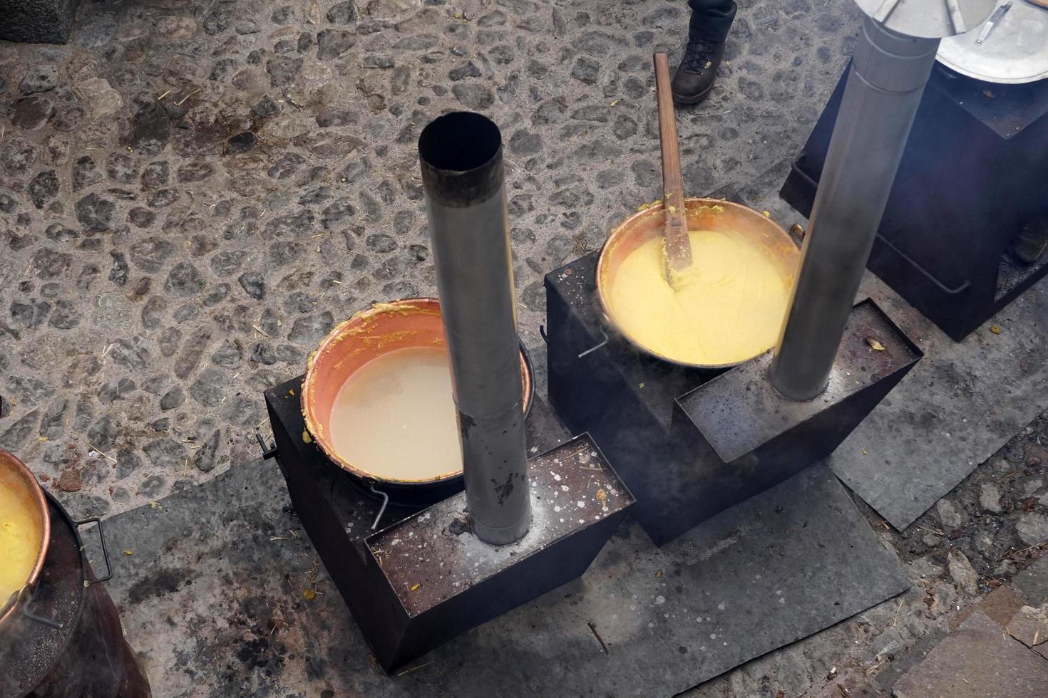 RANGO, ITALY - DECEMBER 8, 2017 - People cooking polenta traditional corn wheat meal photo