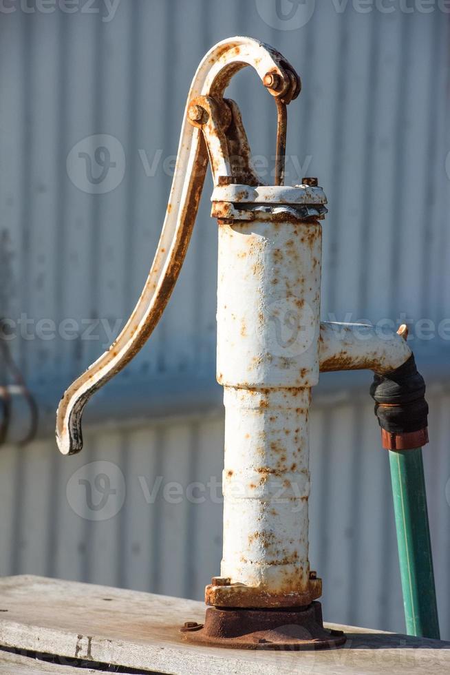 Old metallic hands water pump photo