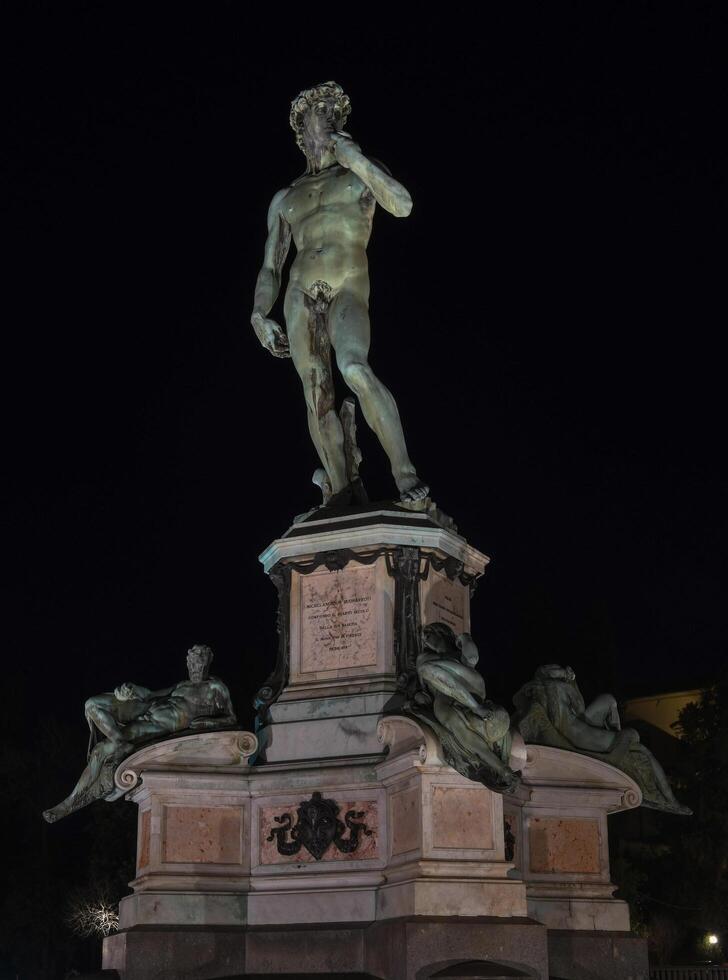 Bronze Statue of David at Michelangelo Park in Florence, Italy at night photo