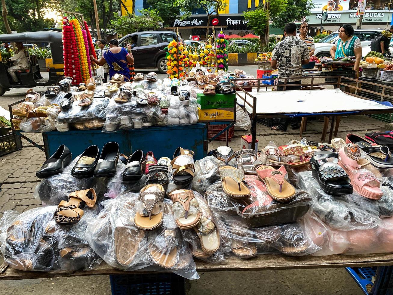 Mumbai, India, October 2022. Cheap footwear for sale at a roadside stall in Mumbai photo