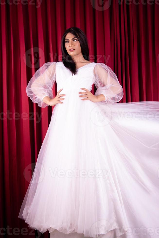 Asian woman posing in a white wedding dress and had black hair photo