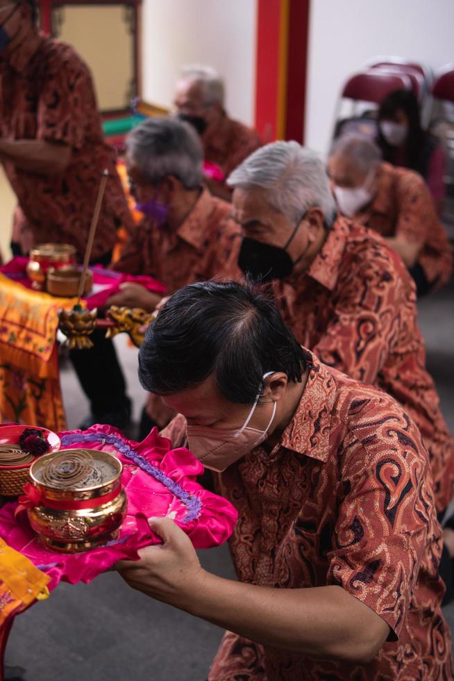 Bandung City, Indonesia, 2022 - the congregation praying together at the Buddhist altar with the monks photo