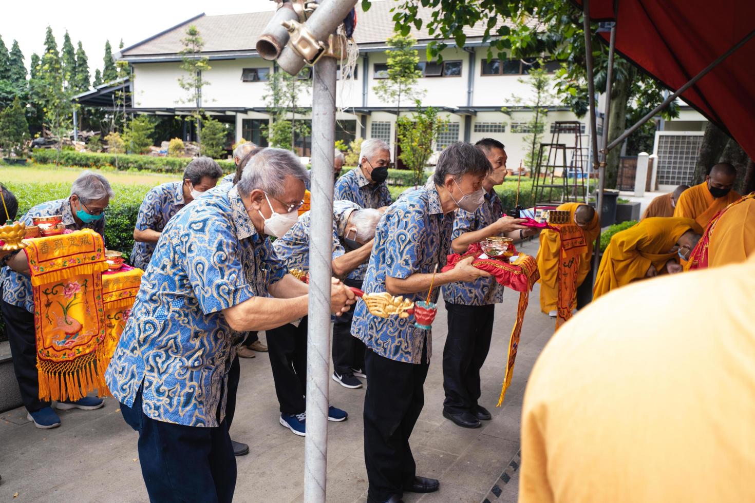 Bandung City, Indonesia, 2022 - The visitor praying together with the monks in front of the offerings to the god photo